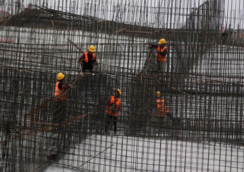 Construction workers labor at a site in Shanghai, China, Oct. 14, 2022.