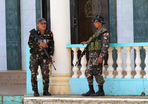 Soldiers guard a lakeside mosque near Marawi after several gunmen aboard a boat were spotted near the area, Sept. 28, 2017. 