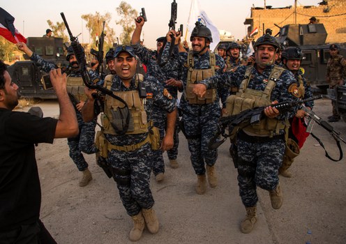 Iraqi federal police celebrate in the Old City of Mosul after the government announced the town had been liberated from Islamic State fighters, July 10, 2017. 