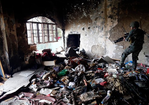 A soldier moves amid debris inside a building taken by Philippine government forces during  fighting with Islamic State-linked militants in the southern city of Marawi, Sept. 14, 2017.