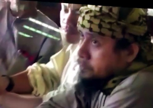 Isnilon Hapilon, identified as the leader of the Islamic State faction who overtook Marawi in May, is seen in this Philippine military video of a militants’ meeting at an undisclosed location. 