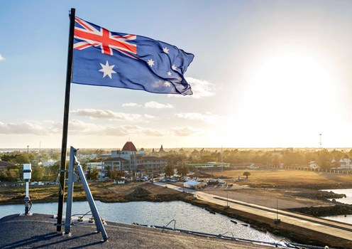 The Australian flag flies on board HMAS Adelaide as the ship arrives in the Tongan capital Nuku’alofa, carrying disaster relief and humanitarian aid supplies following the eruption of underwater volcano Hunga Tonga- Hunga Ha’apai. Pictured on Jan. 26, 2022.