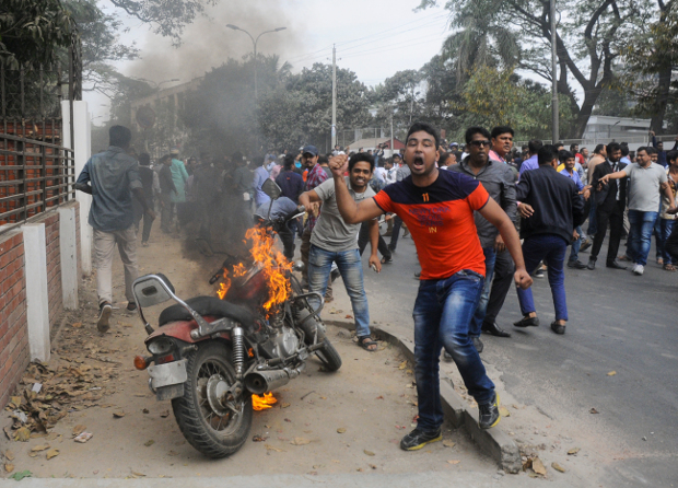 Supporters of the opposition Bangladesh Nationalist Party (BNP) set fire to a motorcycle as they protest a verdict against party leader and former Prime Minister Khaleda Zia in Dhaka, Feb. 8, 2018. 