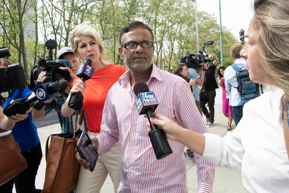 Reporters surround the father of suspect Ashiqul Alam as he leaves federal court in Brooklyn, N.Y., June 7, 2019. [AP]