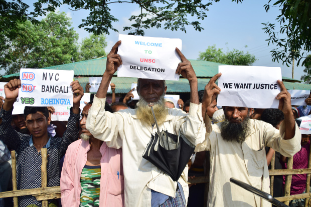 Rohingya refugees hold up placards while U.N. Security Council delegates visit the Kutupalong refugee camp in Ukhia, Cox’s Bazar, April 29, 2018. 