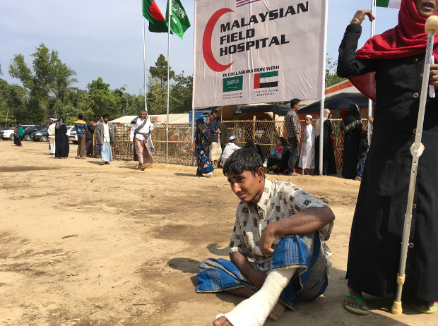 An injured Rohingya boy sits outside the Malaysian Field Hospital in Cox's Bazar after being treated there, Jan. 27, 2018. [Kamran Reza Chowdhury/BenarNews]
