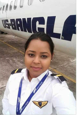 First Officer Prithula Rashid stands in front of a US-Bangla Airlines plane in an undated photo. 