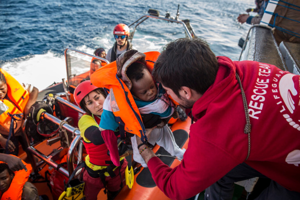 A baby is loaded into the rescue vessel of the Spanish NGO Proactiva Open Arms, after being rescued in the Mediterranean Sea at 45 miles from Al Khums, Libya, Dec. 21, 2018. [AP]