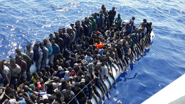 African migrants wait to be rescued while on board an inflatable rubber boat intercepted offshore near the town of Gohneima, east of the Libyan capital, Tripoli, June 24, 2018. [AP]