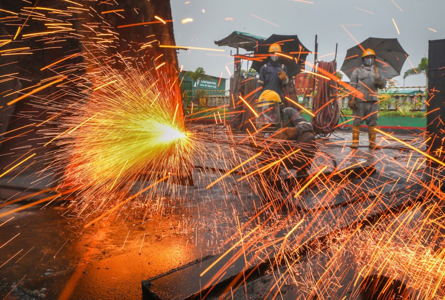 Sparks fly as a worker uses a torch to cut up an old ship at a shipbreaking yard in Tetultala, Chattogram, Bangladesh, Jan. 6, 2025.