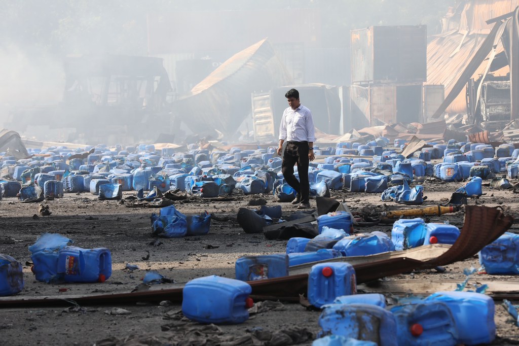 A man walks among debris scattered at the B.M. Container Depot in the Sitakunda sub-district of Chittagong, Bangladesh, two days after an explosion and fire claimed dozens of lives, June 6, 2022. [BenarNews]