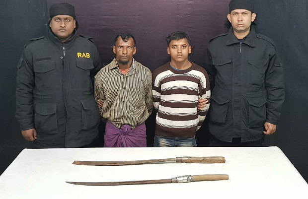 Rapid Action Battalion (RAB) personnel present Rohingya suspects Nur Mohammad, 30, and Ataur Rahman, 16, who allegedly confessed to killing a Rohingya camp leader because he supported refugee repatriation to Myanmar. 