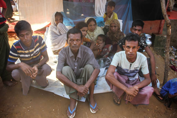 Mohammad Javed (right), a Rohingya refugee in Cox’s Bazar, says his 11-member family barely gets by on one meal a day, Nov. 8, 2017. [Rohit Wadhwaney/BenarNews]