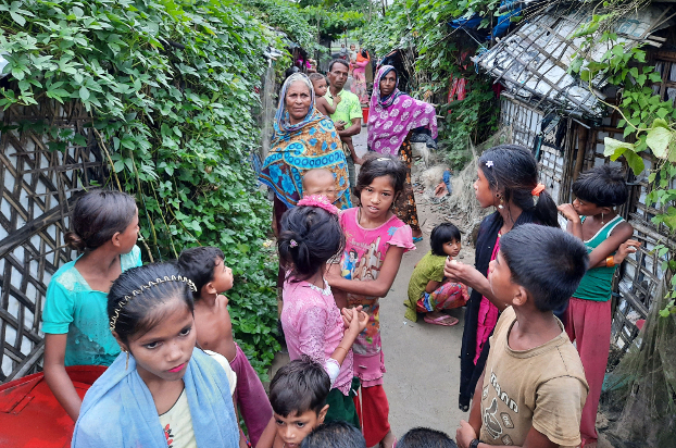 Rohingya women and children stand outside their homes in the Baharchara refugee camp in Teknaf in Cox’s Bazar, Bangladesh, Aug. 16, 2020. [Sunil Barua/BenarNews]