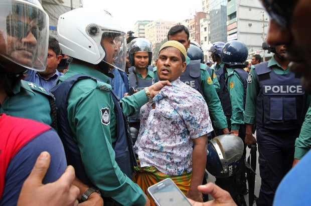 Police question a suspected demonstrator as hundreds of activists rallied to express their support for former Prime Minister Khaleda Zia in Dhaka, Feb. 9, 2018. [Monirul Alam/BenarNews]  