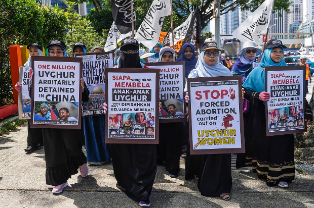 Malaysian demonstrators carry signs criticizing the detention of Uyghurs in China’s Xinjiang region, during a protest rally outside the Chinese embassy in Kuala Lumpur, Dec. 27, 2019. [S. Mahfuz/BenarNews]