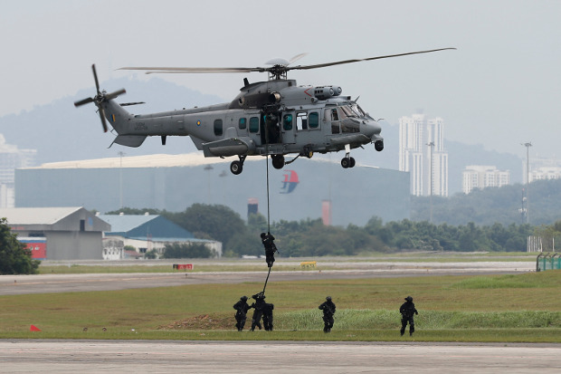 Special Forces demonstrate skills during a drill in combatting terrorism from a helicopter after the launching of joint patrols between Malaysia, Indonesia and Philippine at the Subang military airbase in Petaling Jaya, Malaysia, Oct. 12, 2017. 