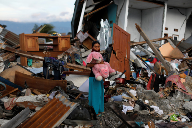 A woman holds a stuffed rabbit after it was found at her destroyed home, where she said she had lost her three children in earthquakes and a tsunami that battered Palu, in Indonesia’s Central Sulawesi province, Oct. 7, 2018. 