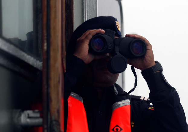 A crew member aboard a rescue ship scans the sea with binoculars during a search operation for the Lion Air plane crash in waters off Tanjung Karawang, Indonesia, Oct. 31, 2018. [AP]