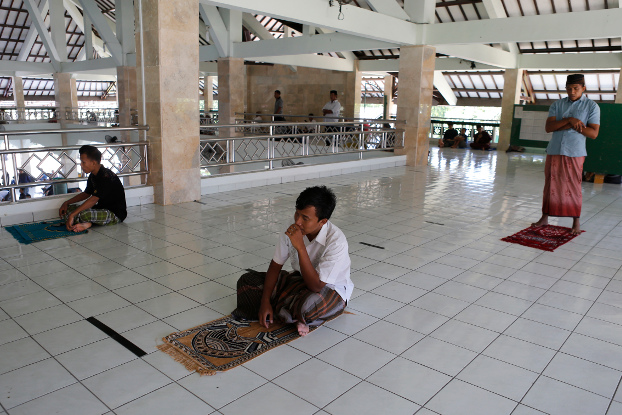 Muslims practice social distancing linked to COVID-19 while attending Friday prayers at a mosque in Bali, Indonesia, March 20, 2020. (AP)