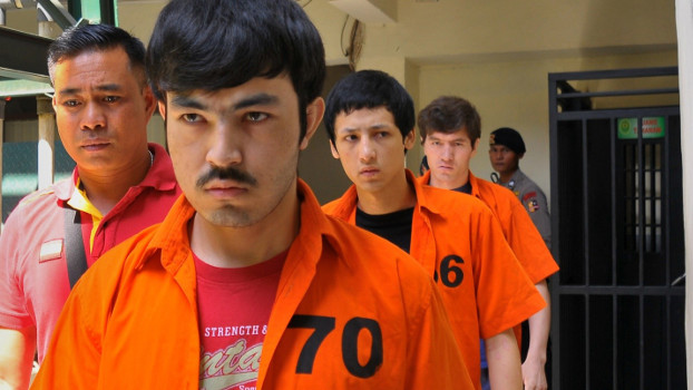 Three Uyghur detainees arrested in Poso Regency in 2014 walk to the court room in Jakarta ahead of their verdicts on terrorism charges, July 13, 2015. (AFP) 