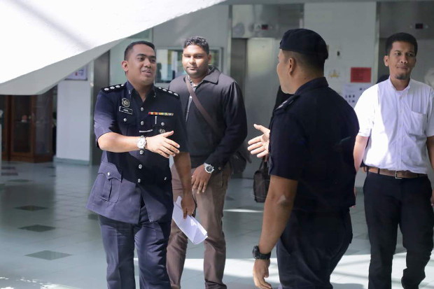 Wan Azirul Nizam Che Wan Aziz (left), case investigator in the murder of Kim Jong Nam, leaves the High Court in Shah Alam, near Kuala Lumpur, after testifying for the prosecution, Oct. 25, 2017. [Hadi Azmi / BenarNews]