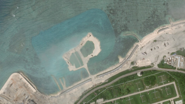 Satellite imagery shows a patch of reef in Woody Island’s northwest that has been dredged up, as indicated by the blue color of the water around it, Oct. 5, 2020. [Planet Labs Inc.]