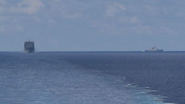 A photo taken from the littoral combat ship USS Montgomery, shows the USNS Cesar Chavez (left) and a Chinese Navy warship, May 7, 2020. [Courtesy U.S. Navy]