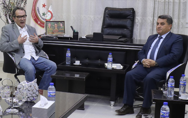 British MP Maurice Glasman (left) meets with Kurdish official Abdulkarim Omar in the northern Syrian city of Qamishli, April 4, 2018. [AFP]
