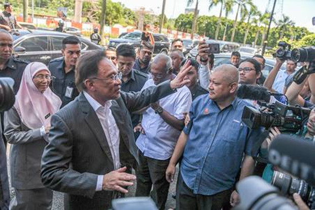 Anwar Ibrahim and his wife, Deputy Prime Minister Wan Azizah Wan Ismail, arrive at the headquarters of the People's Justice Party in Malaysia’s Selangor state, Feb. 24, 2020. [S. Mahfuz/BenarNews]