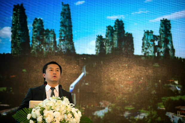 Huang Yuzang, vice president and chief developer at Country Garden, announces a competition offering prize money for an eco-friendly landmark piece of architecture for the firm's Forest City development in Malaysia, Aug. 13, 2016. (AP)