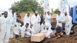 Papua New Guinea carries out mass burial to ease morgue overcrowding