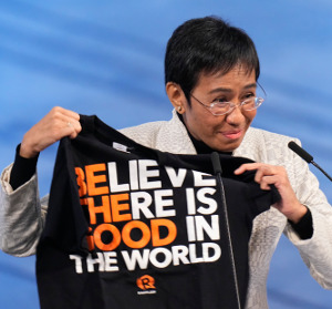 Philippine journalist Maria Ressa holds up a t-shirt during the Nobel Peace Prize ceremony in Oslo, Dec. 10, 2021. [AP]