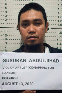 Abduljihad Susukan, a suspected commander of the Abu Sayyaf militant group, poses for a photo at the Davao City police station in the southern Philippines after he was taken into custody, Aug. 13, 2020. [Handout photo from Philippine National Police via AP]