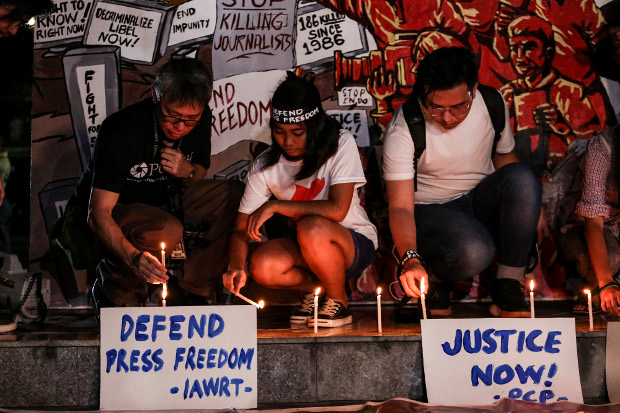 Filipino journalists and activists join a candle-lighting ceremony on the eve of the verdict in the Ampatuan Massacre case, in Quezon City, Philippines, Dec. 18, 2019. [Basilio Sepe/BenarNews]