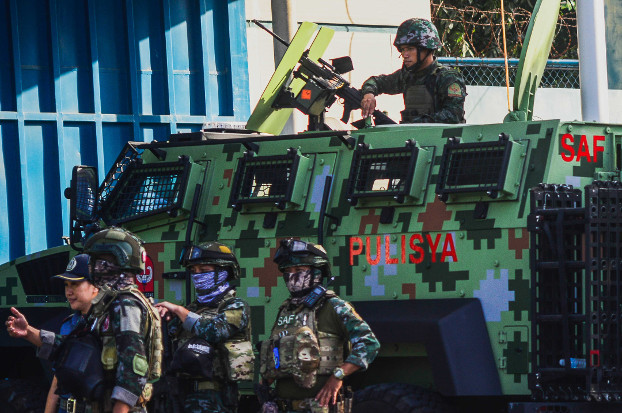 Philippine police man a Special Action Force anti-personnel vehicle during a security lock down at Camp Bagong Diwa, in preparation for the 2009 Ampatuan massacre verdict, Dec. 19, 2019. [Jojo Riñoza/BenarNews]