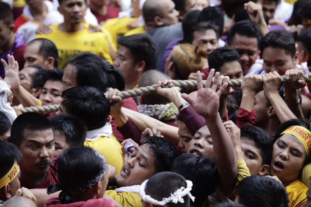 Filipinos shove one another as they try to get close the statue of the Black Nazarene during its procession in Manila, Jan. 9, 2019. [Luis Liwanag/BenarNews]