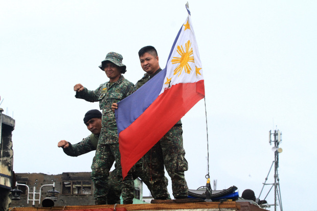 Philippine soldiers celebrate in Marawi after President Rodrigo Duterte declared the “liberation” of the southern city from Islamic State-linked militants, Oct. 17, 2017. 