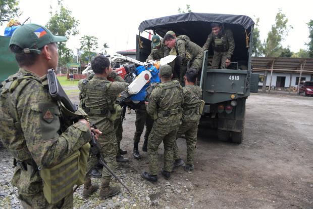 Philippine government troops load a small tractor onto a truck in the town of Butig, southern Philippines, July 28, 2019. [Froilan Gallardo/BenarNews] 