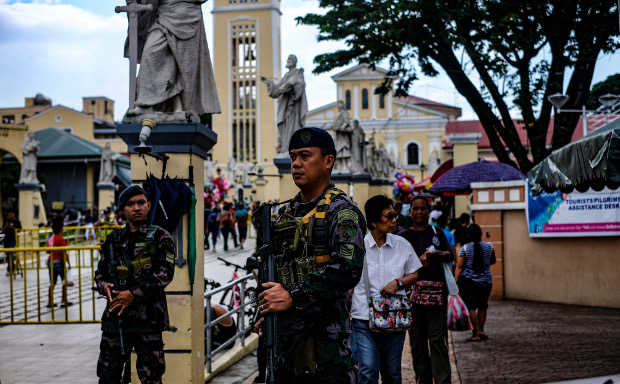 Government security personnel guard an entrance to the Our Lady of Manaoag Church in Manaoag, Philippines Aug 11, 2019. [Jojo Rinoza/BenarNews]