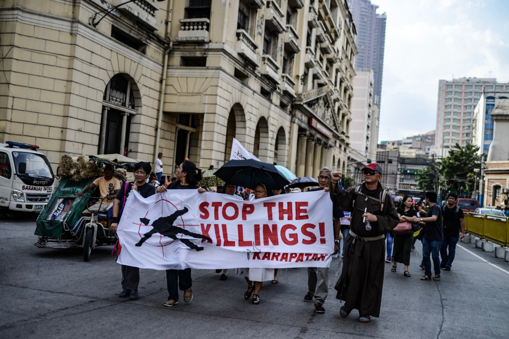 Members of the Catholic clergy join a protest march in Manila demanding an end to extrajudicial killings in the Philippines, Aug. 21, 2019. [Jojo Rinoza/BenarNews]