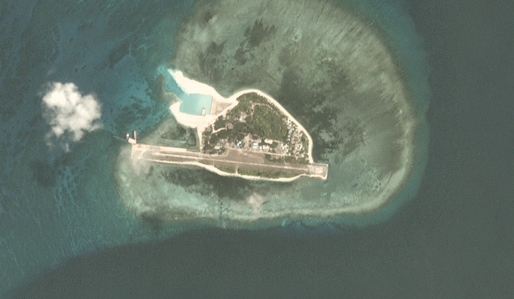 This satellite image shows Thitu Island as of May 22, 2020. The runway has been fortified and the nearly completed beaching ramp is visible in the upper left. [PhotoLabs INC]