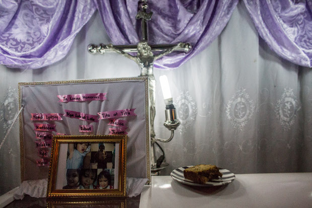 Photos of Myca Ulpina, a 3-year-old Filipina who was killed by gunfire during a police counter-narcotics operation, are seen during her wake in Rizal province, Philippines, July 5, 2019. [Basilio Sepe/BenarNews]