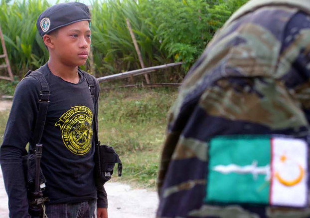 A boy stands at attention at the remote Moro National Liberation Camp in Jolo, May 29, 2016. [Mark Navales/BenarNews]