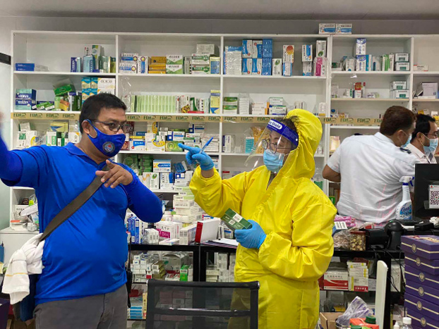 Philippine National Police officers inspect a pharmacy linked to an alleged medical facility set up to treat Chinese COVID-19 patients in the northern Philippine town of Mabalacat, May 19, 2020. [Philippine National Police via AP]