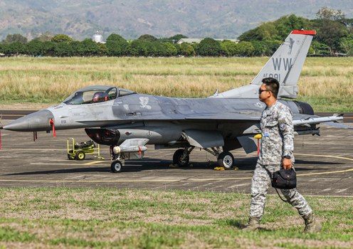 A member of the Philippine Air Force walks past a U.S. Air Force F-16 fighter jet during the “Cope Thunder” joint exercise at Basa Air Base in Pampanga, April 11, 2024.