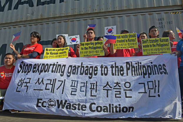 Activists with the Ecowaste Coalition, an environmental group, stage a rally in front of container vans loaded with household waste at the Mindanao Container Terminal in Tagoloan, Misamis Oriential province, southern Philippines, Jan. 13, 2019. (Froilan Gallardo/BenarNews)