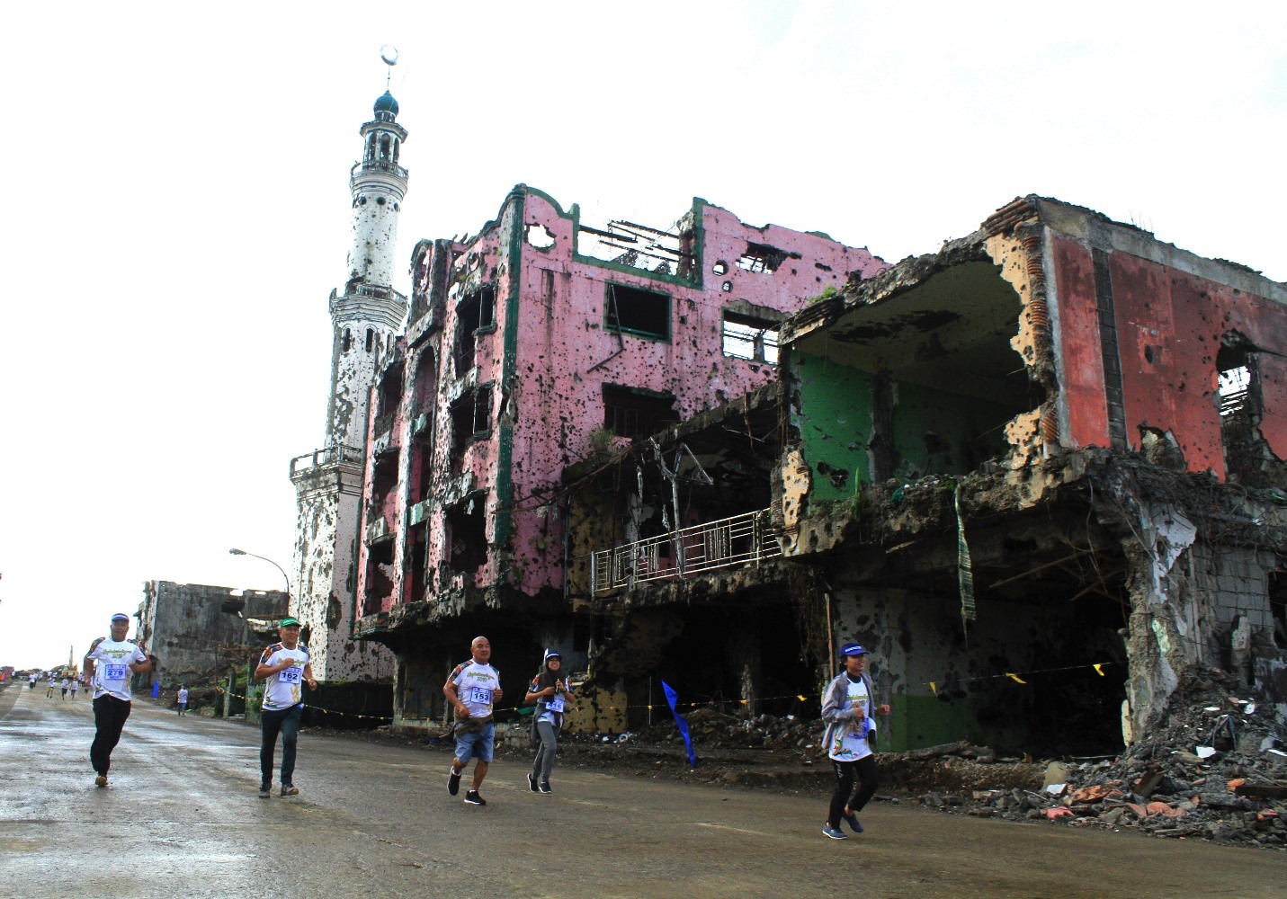 Runners join a “fun run” fundraiser in the ruined commercial district of Marawi, where Islamic State-linked militants engaged Philippine security forces in vicious firefights two years ago, Oct. 17, 2019. (Photo: Richel V. Umel/BenarNews)