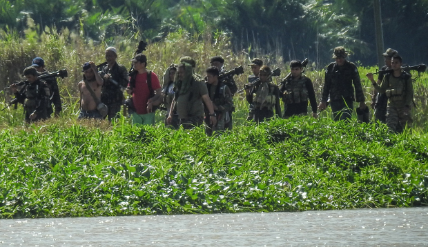 Moro Islamic Liberation Front rebels patrol an area once held by pro-Islamic State militants in Datu Salibo, in the southern Philippine province of Maguinadanao, Sept. 5, 2017. [AFP] 