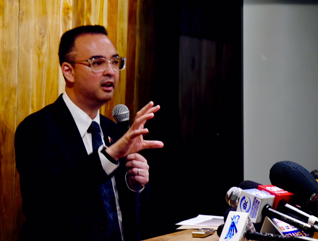 Philippine Foreign Secretary Alan Peter Cayetano gestures as he talks to reporters in Manila, July 7, 2018. 